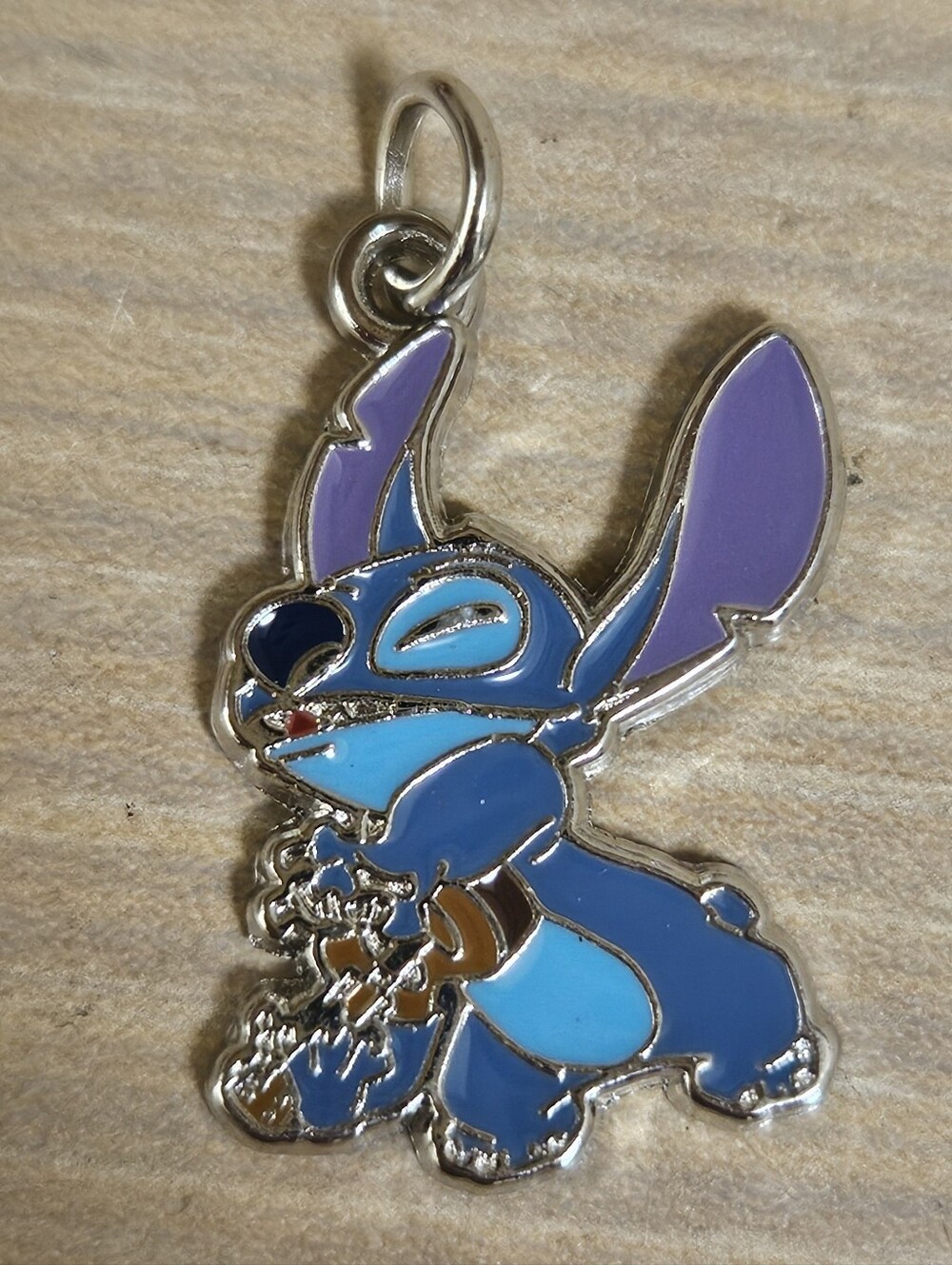 Disney Lilo & Stitch enamel charm featuring Stitch happily playing ukulele Music